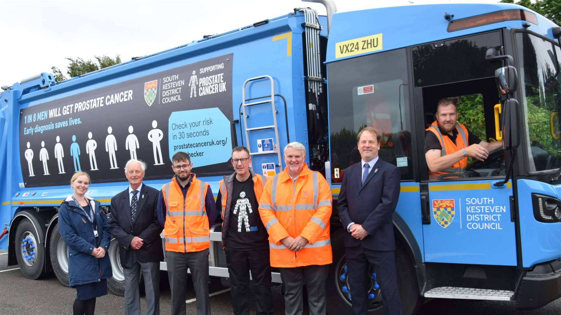 Launch attendees with the new bin lorry.