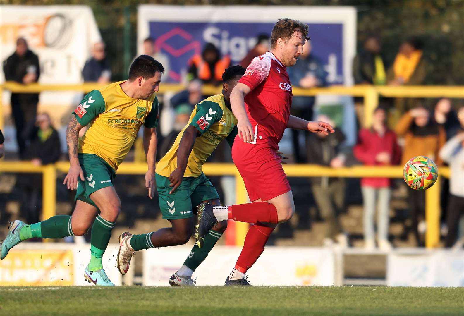 Tom Siddons looks to break away from two Hitchin players. Photos: Rob O’Brien