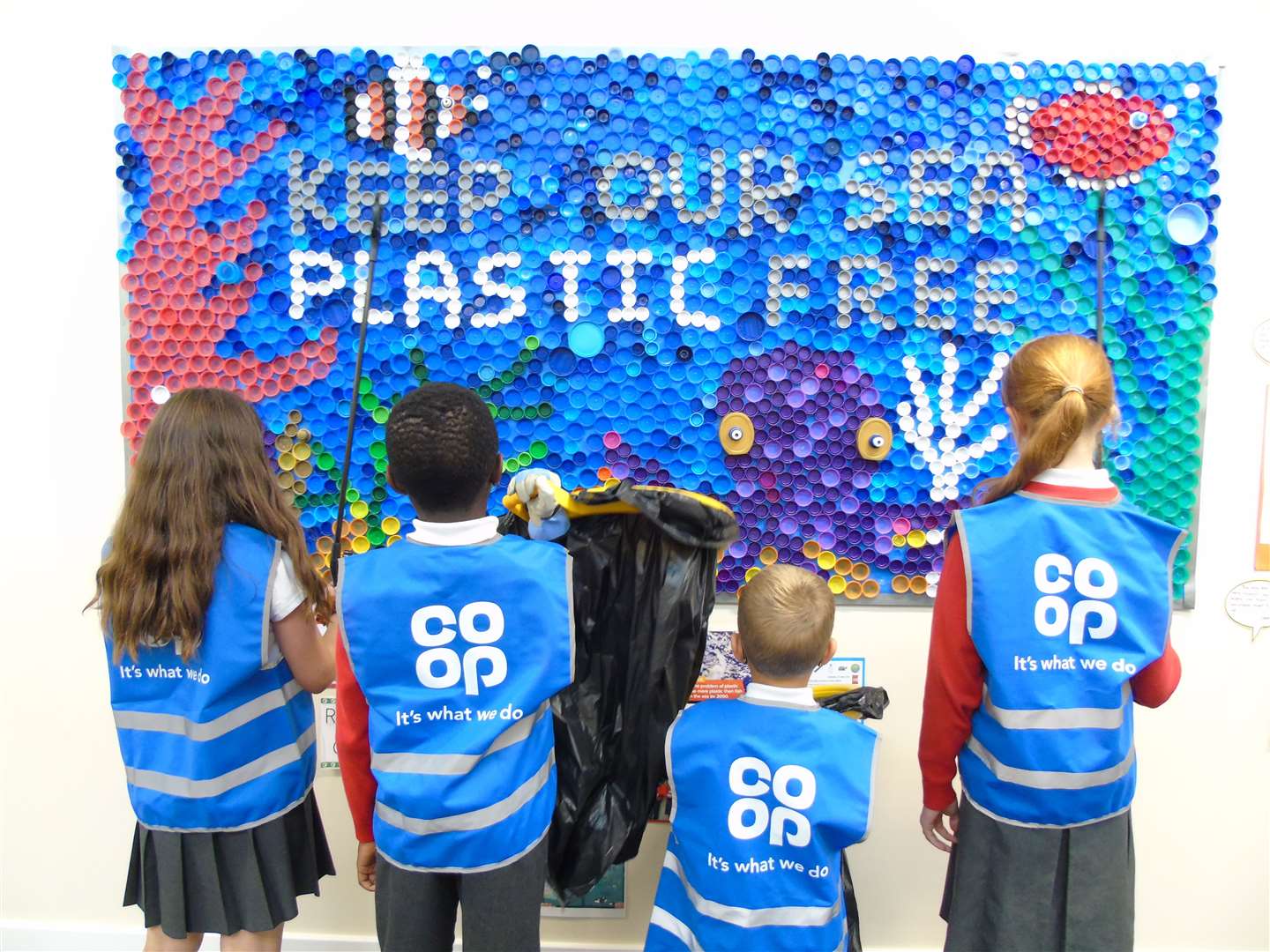 Pupils at Bourne Elsea Park CE Primary Academy with the litter pickers donated by the Co-op