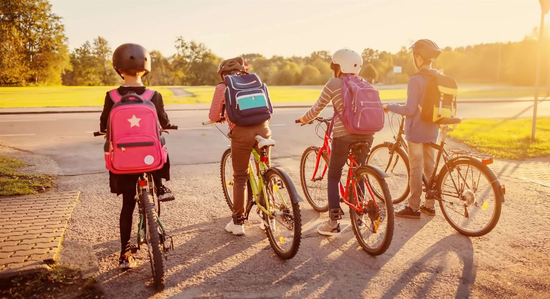 Boys and girl riding by bicycle to school. Photo: istock