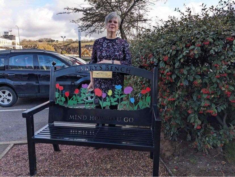 Wife Lesley with the memorial bench.