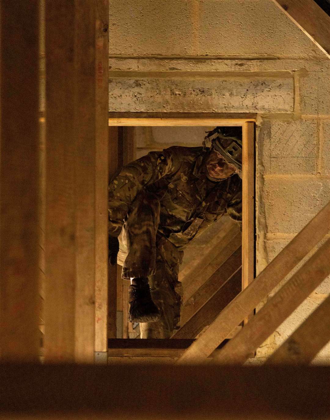 Private Warren crawls through roof rafters.