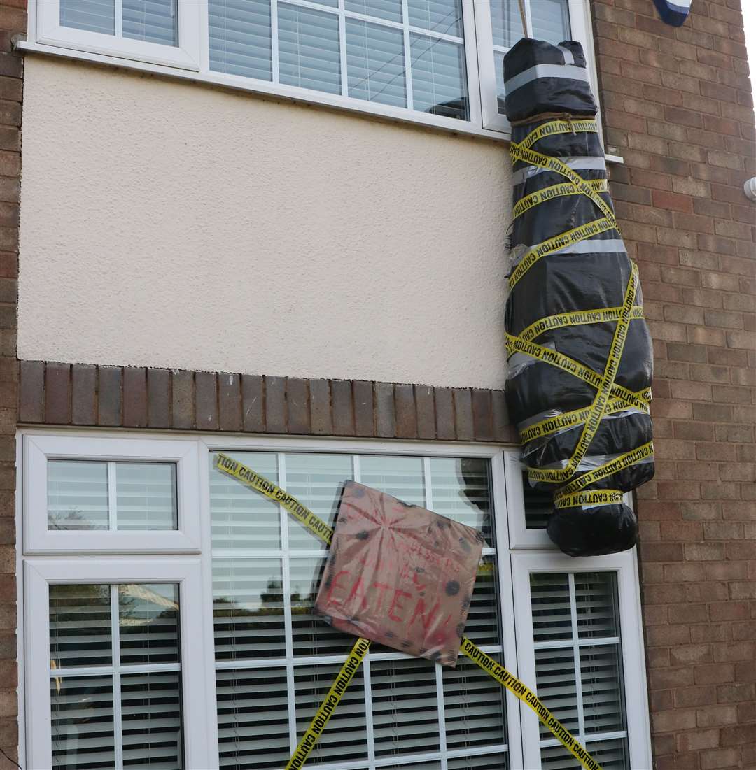 Bodies hang from the upstairs windows