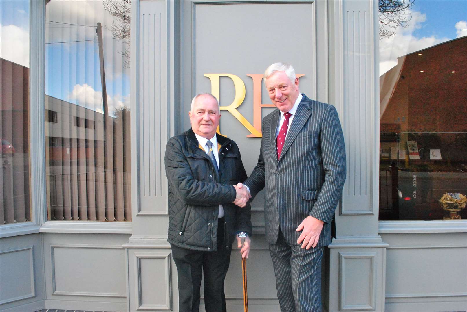 Robert Holland (right) presents a walking stick to former employee David Mitchell. (62843379)