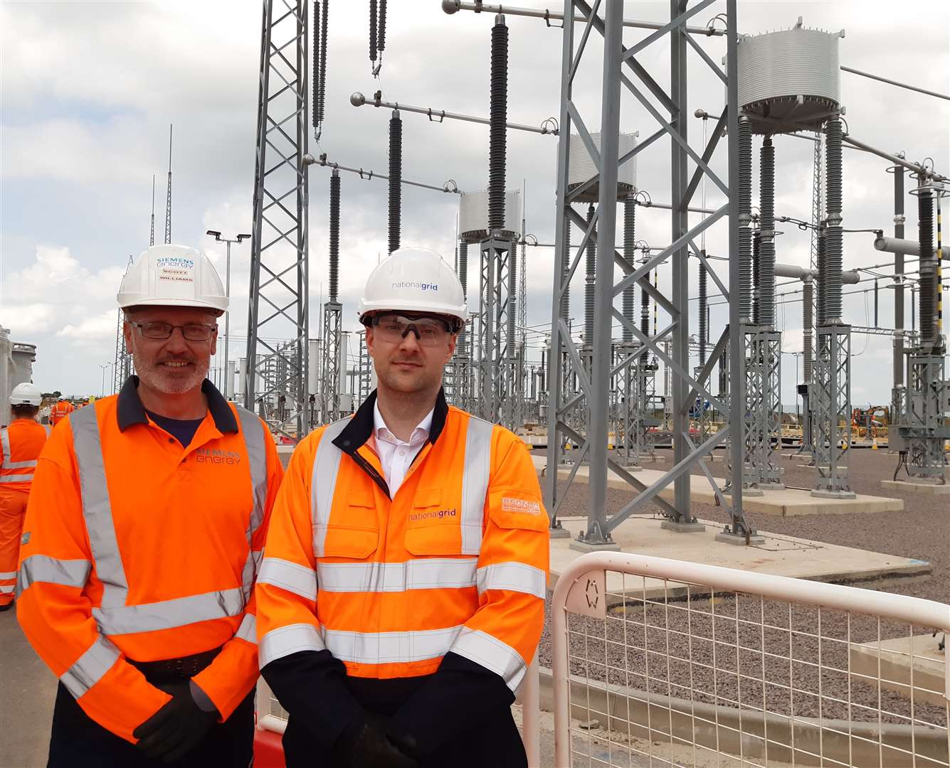 Scott Williams and Phil Sandy in front of the electrical equipment at the Viking Link Interconnector