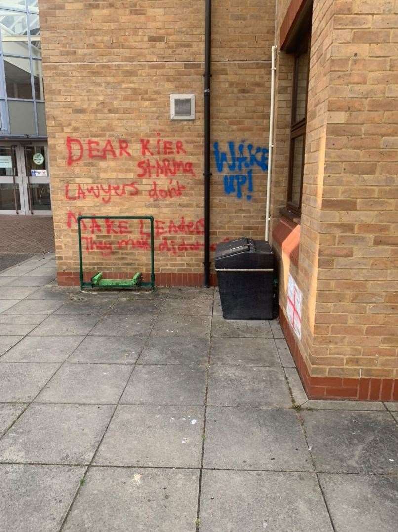 The graffiti is located at the side of the building