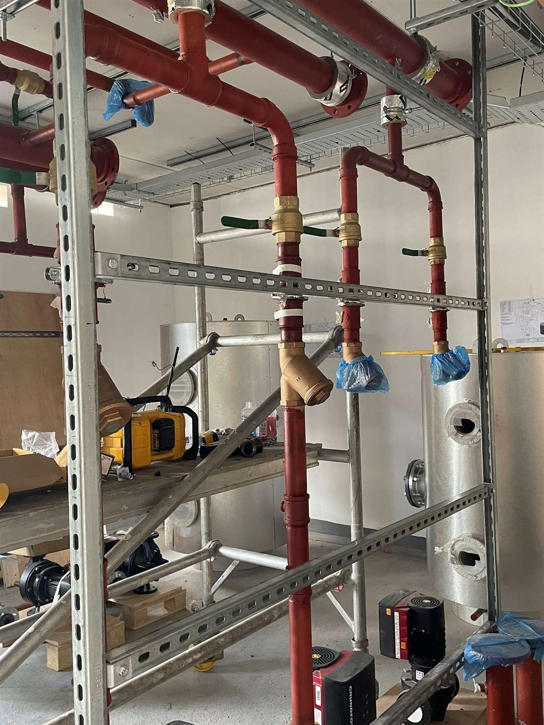 Exposed pipework will be covered before Stamford Hospital Day Treatment Centre opens in the summer