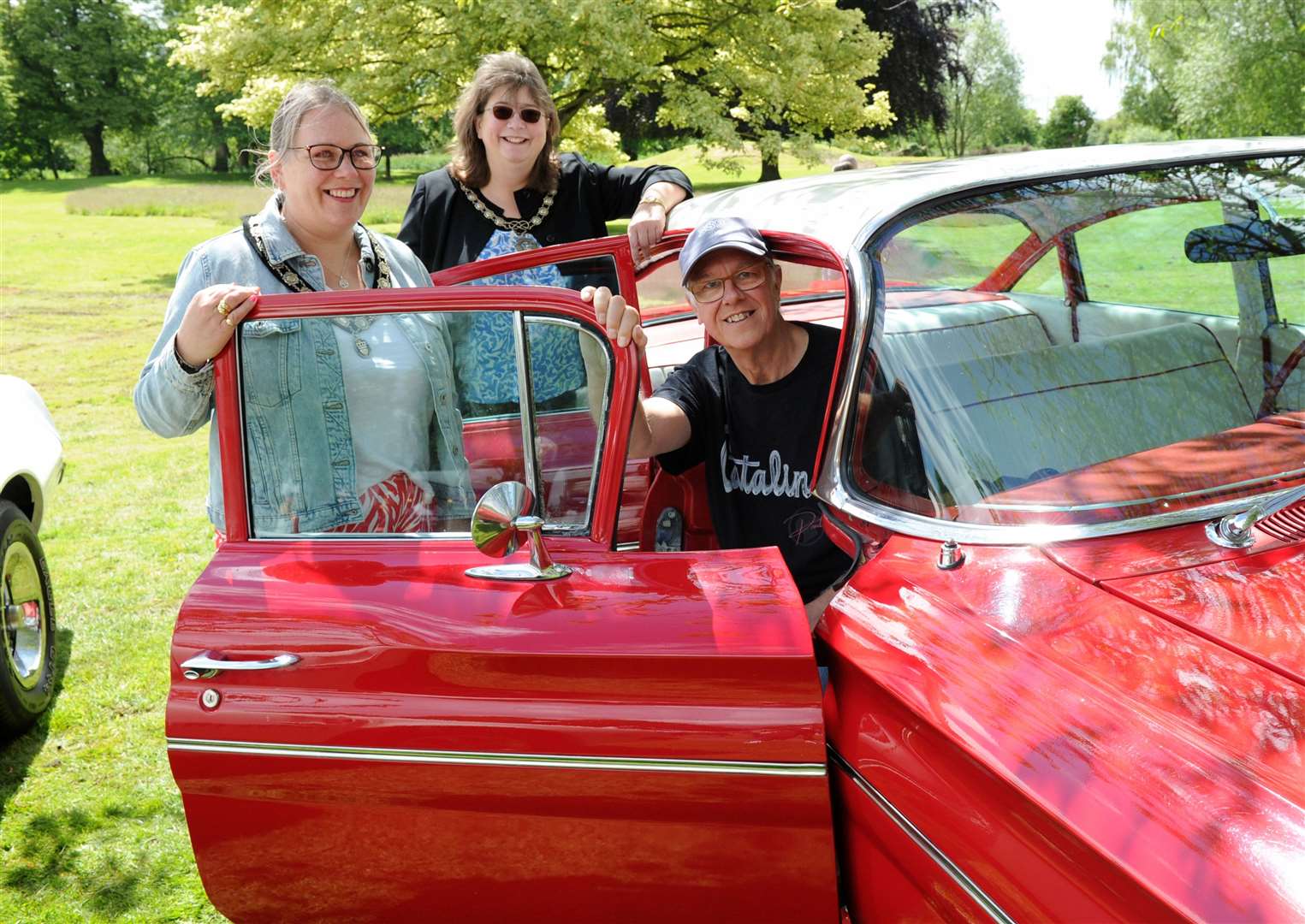Adrian Ball, from Bourne, shows off his 1060 Pontiac Catalina to Mayor of Bourne, Helen Crawford and consort Nicola Hampton. Photo: Iliffe Media