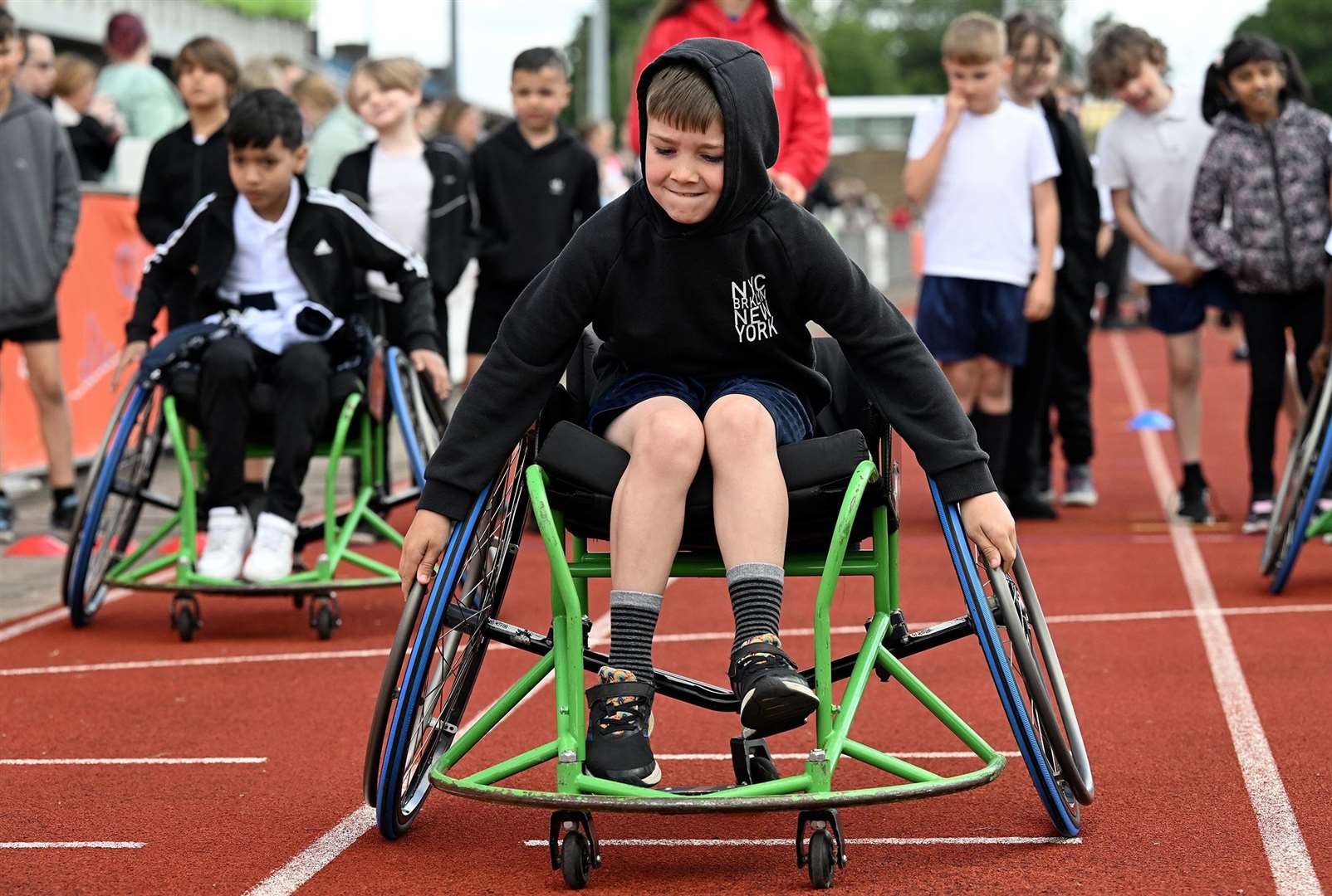 The children having a go at wheelchair racing on day one.