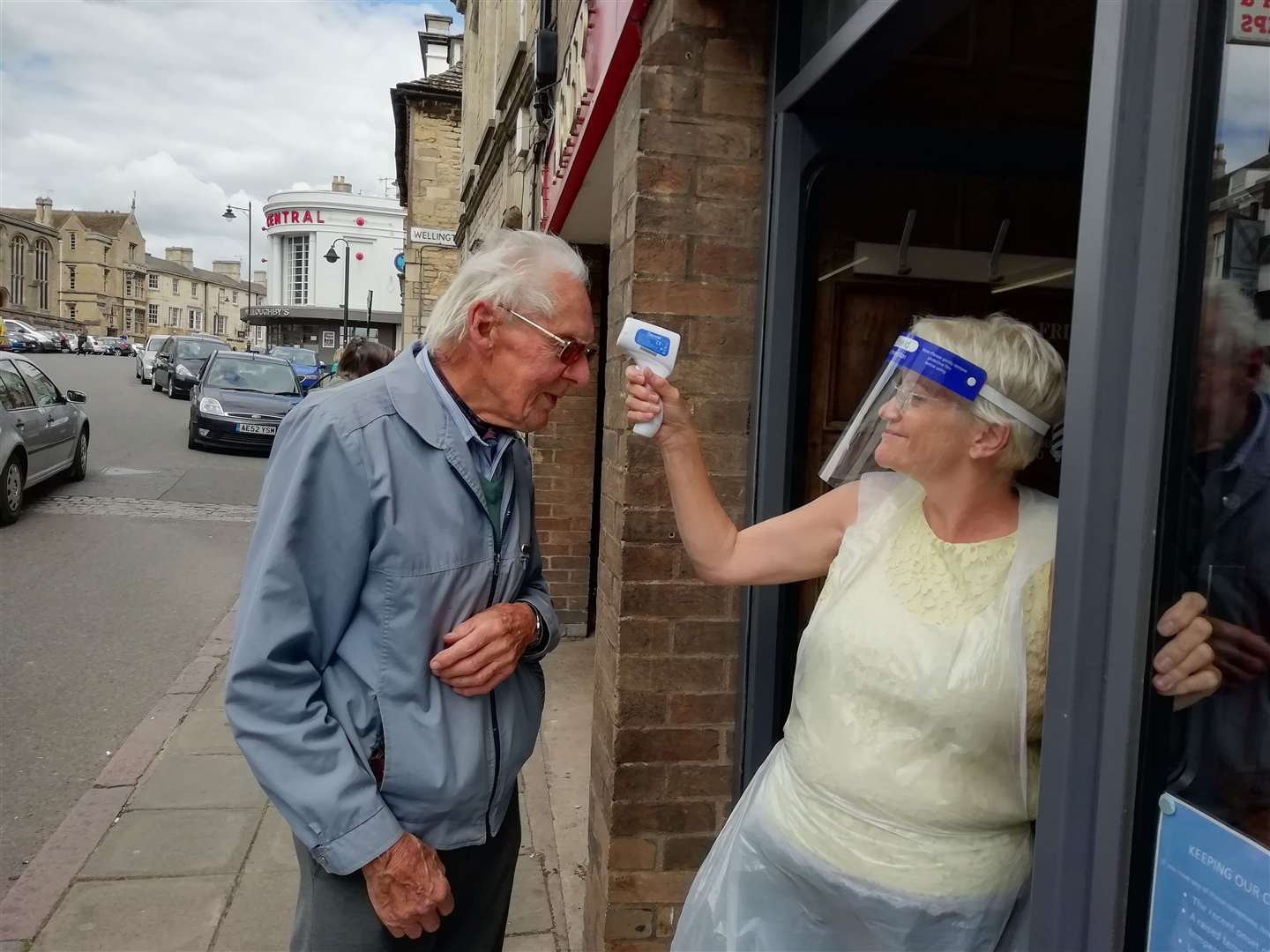 Michael Crowe from Uffington has his temperature checked before a hair cut at Beyond the Fringe in Red Lion Street, Stamford