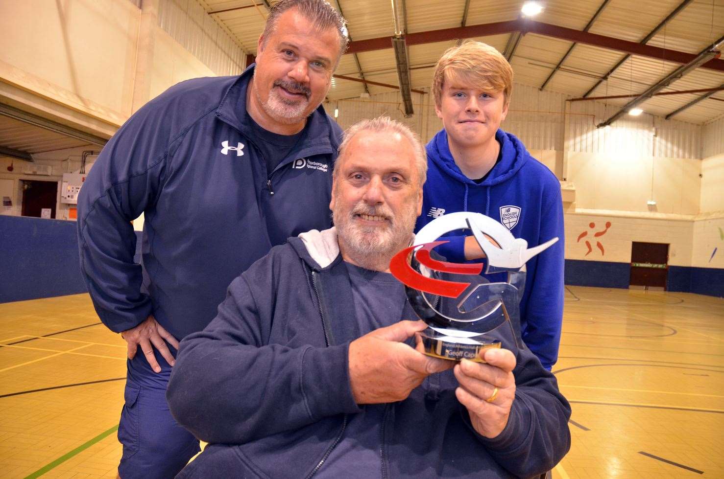Geoff Capes with his England Athletics Hall of Fame award alongside son Lewis and grandson Donovan. Photo by Tim Wilson. SG-141018-4.