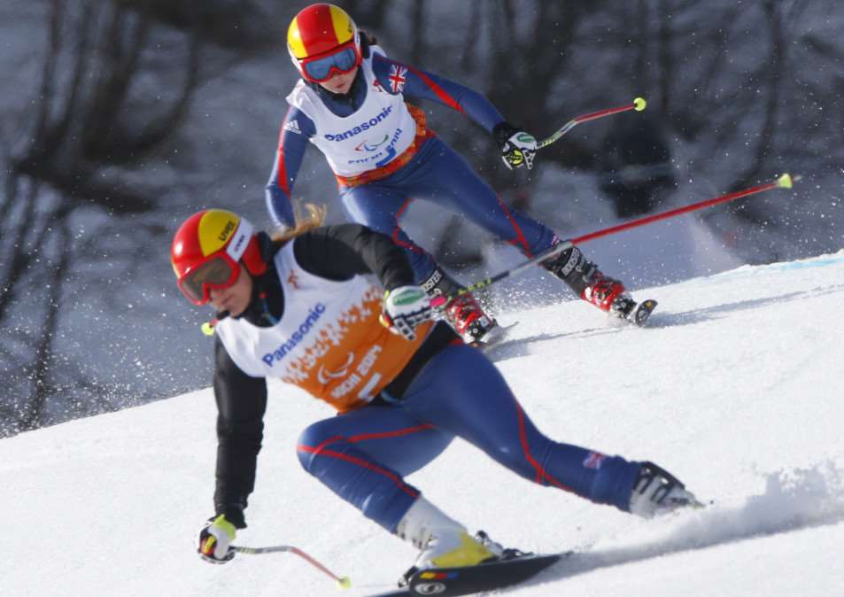 Great Britain's Jade Etherington, above, and her guide Caroline Powell race to win bronze medal in the alpine skiing, ladies, Super-G, visually Impaired event at the 2014 Winter Paralympic, Monday, March 10, 2014, in Krasnaya Polyana, Russia. (AP Photo/Dmitry Lovetsky) EMN-140313-103133001