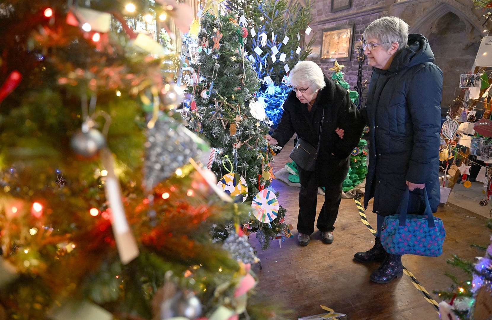 Visitors enjoying the St Wulfram's Christmas Tree Festival and skating rink.