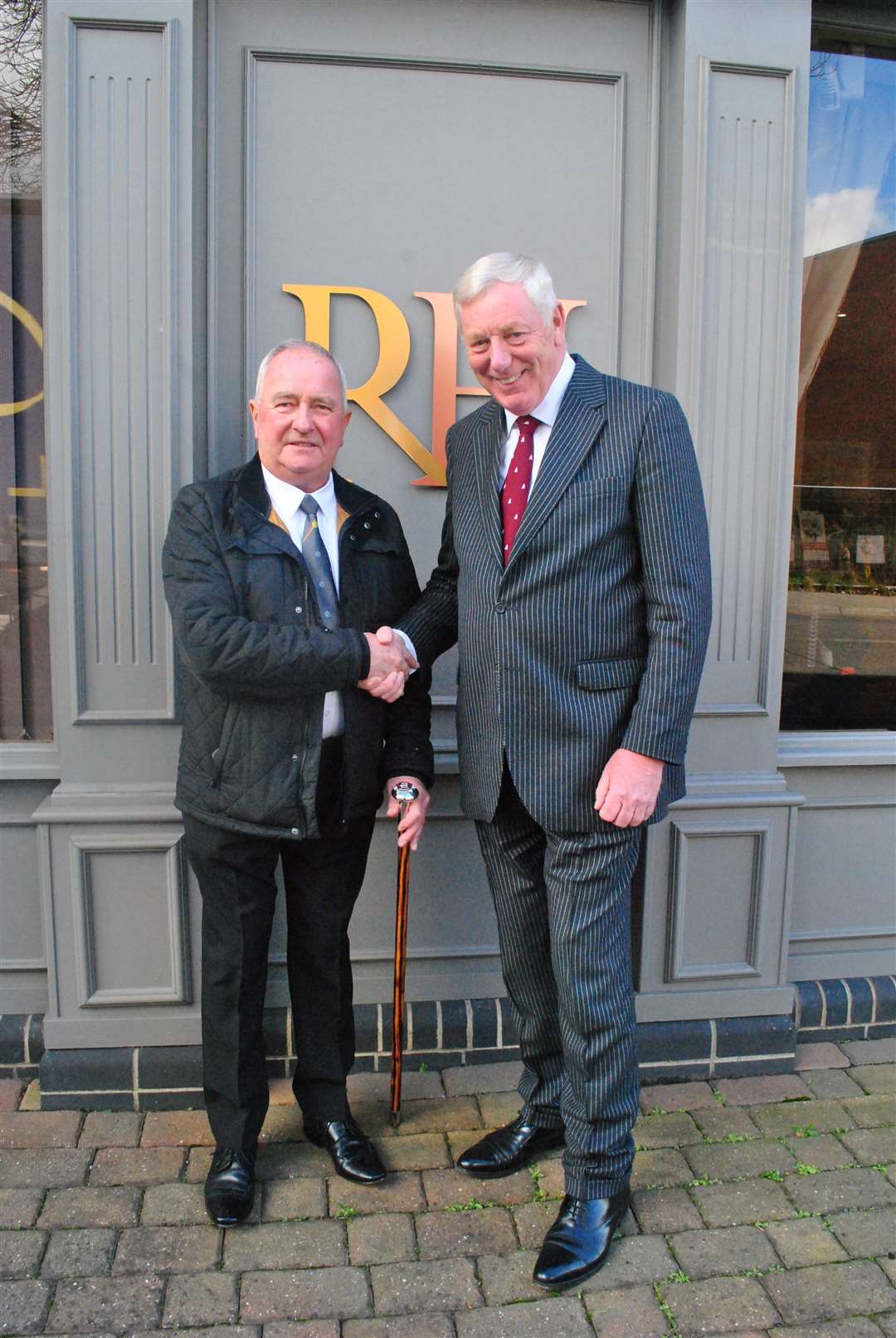 Robert Holland (right) presents a walking stick to former employee David Mitchell. (62843374)