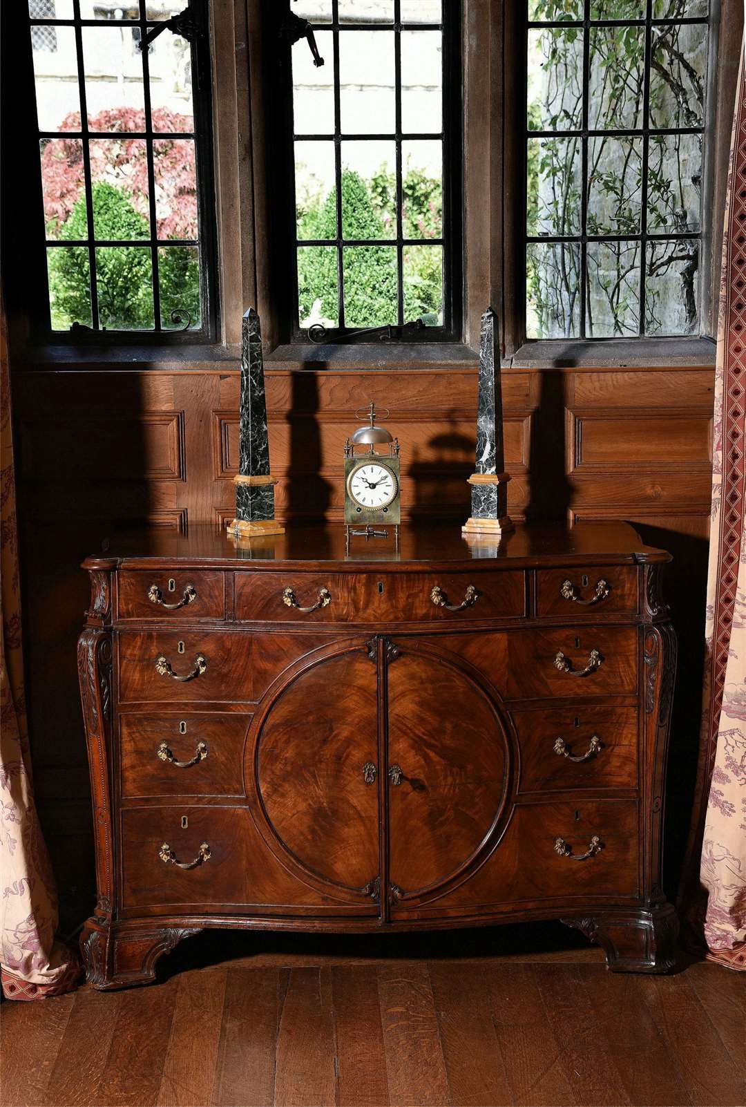 Lot 128: A George III figured mahogany serpentine commode, in the manner of Thomas Chippendale, circa 1770 | Est. £20,000-30,000 (+ fees). (58822227)