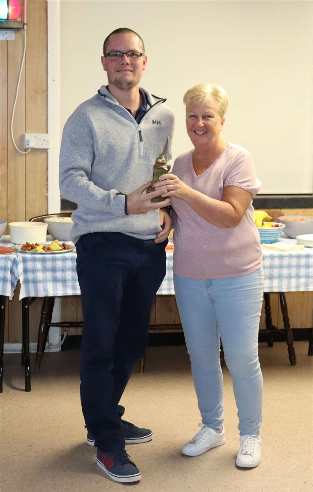 Tom Bell, pictured with Commodore Sarah Prior, won the Grounds Trophy
