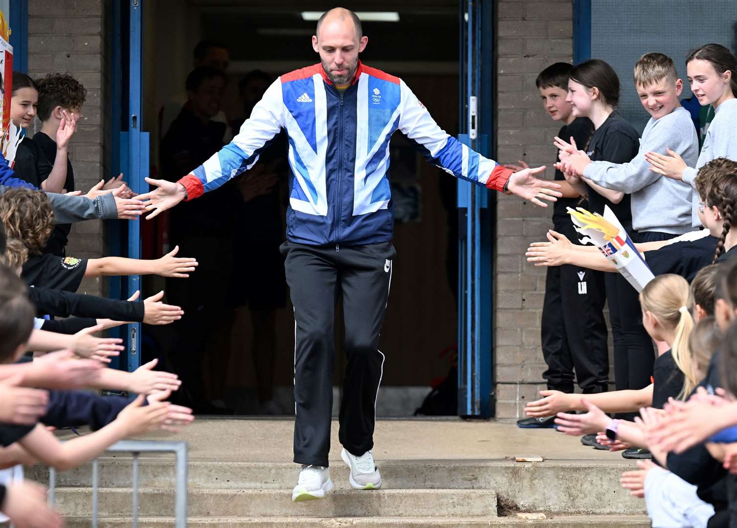 Children welcome their special guest on day two.