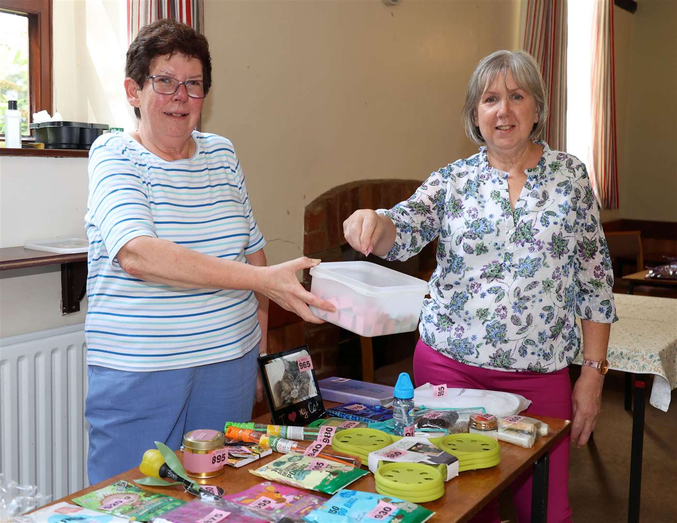 Wendy Beeby (right) has a go on the tombola, hoping to pick a winning ticket from Wendy Houghton