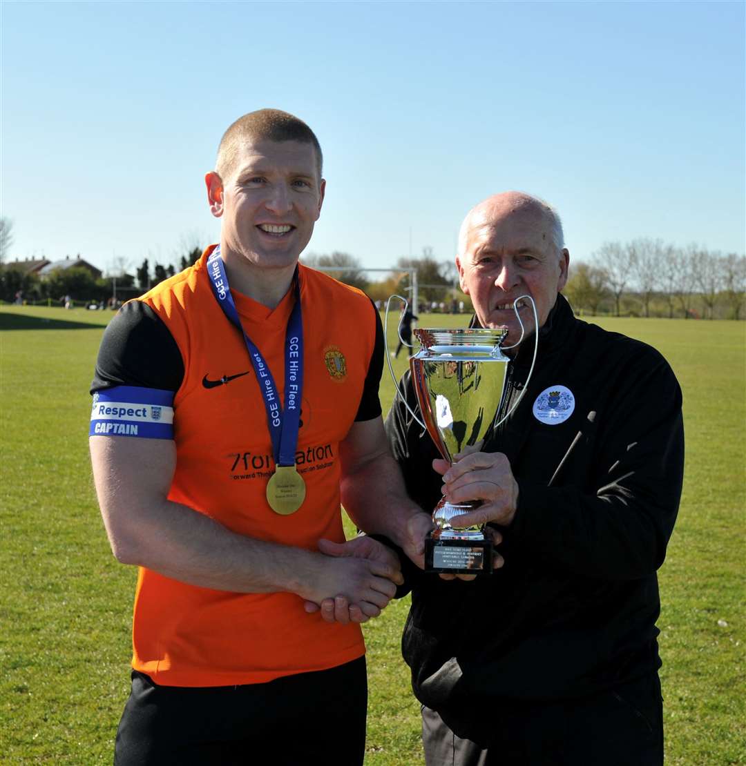 Skipper Dave Atkinson receives the trophy from Trevor Mitchell. Photo: Chris Lowndes