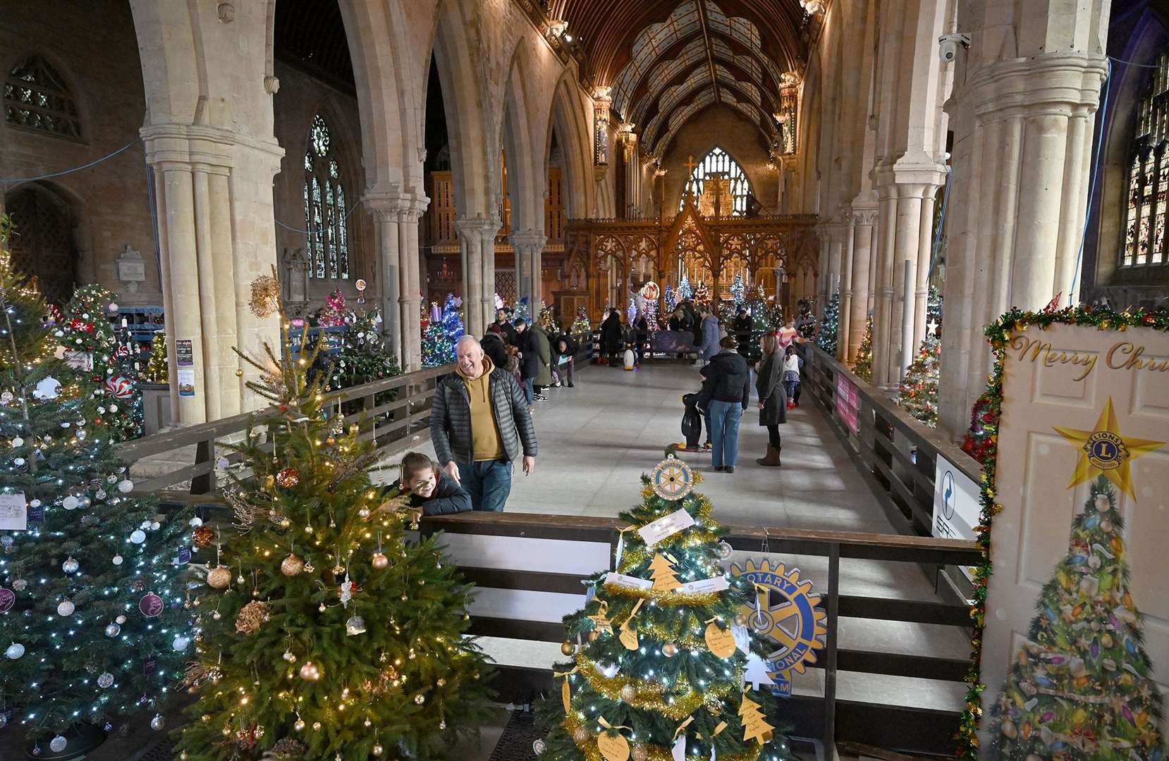 Visitors enjoying the St Wulfram's Christmas Tree Festival and skating rink.