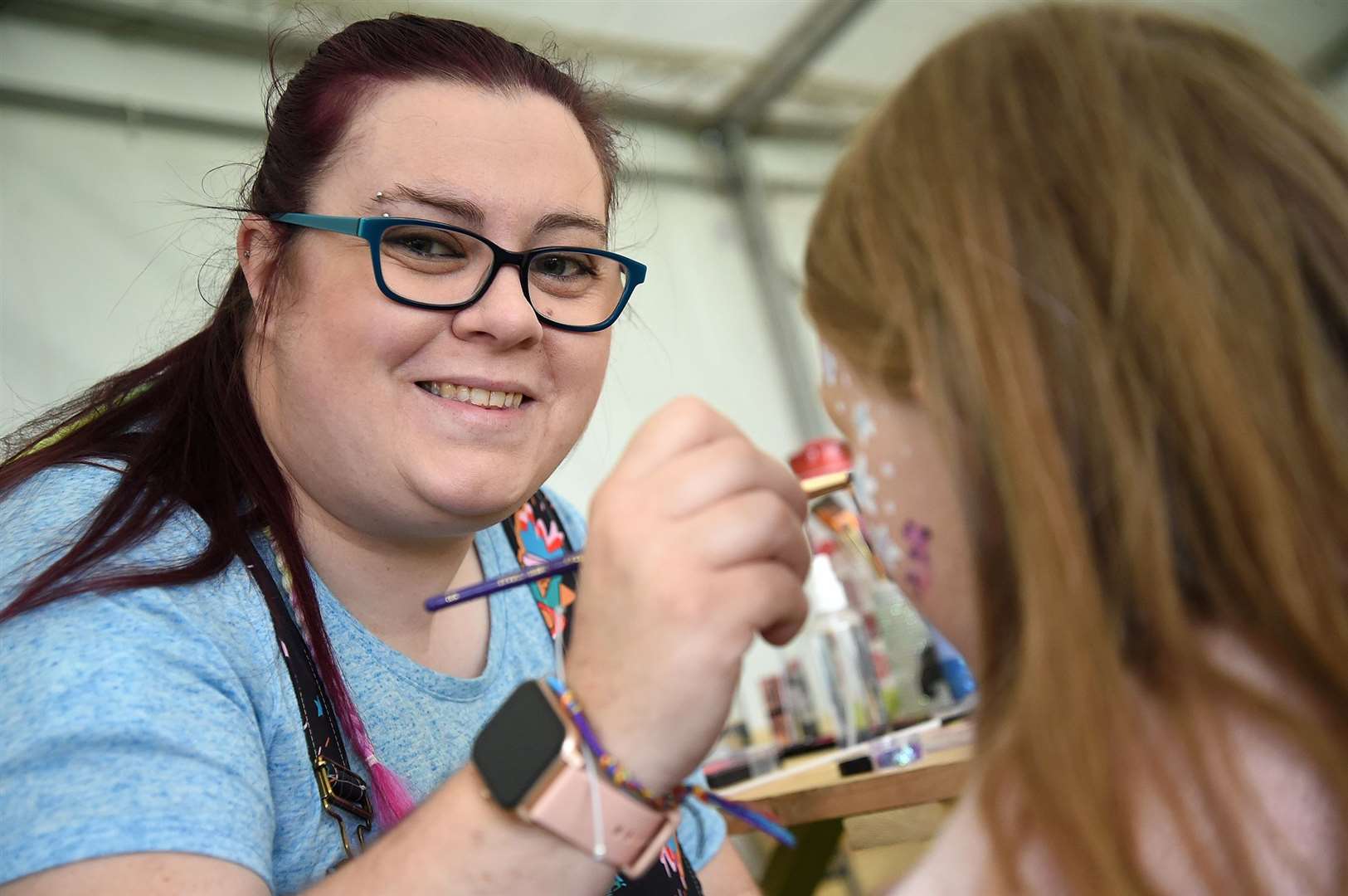 Geccikka Rylance providing the face paint for children.