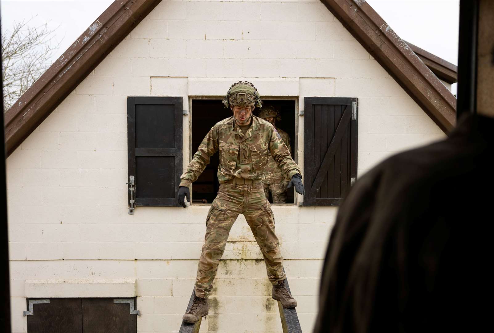 The soldiers had to balance across two steel girders from house to house.