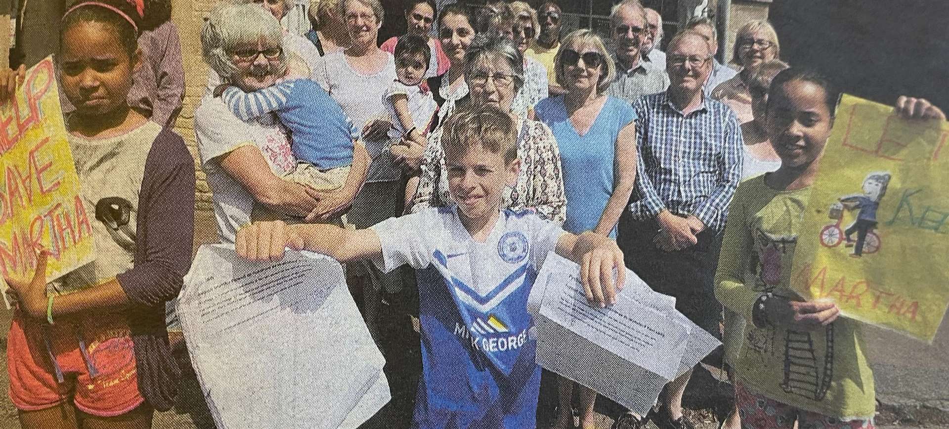 Youngsters Jodi and Rebecca O'Sullivan with George Weed (centre) together with locals from Wansford with a petition to get back their postie 10 years ago.