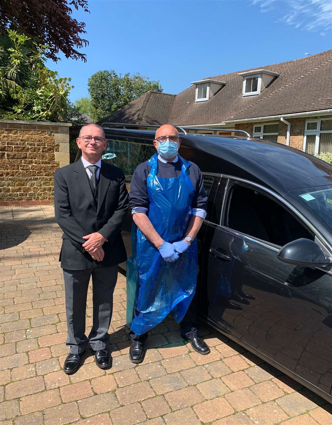Funeral operatives Michael Smith in the apron and Geoff Angell in the black suit