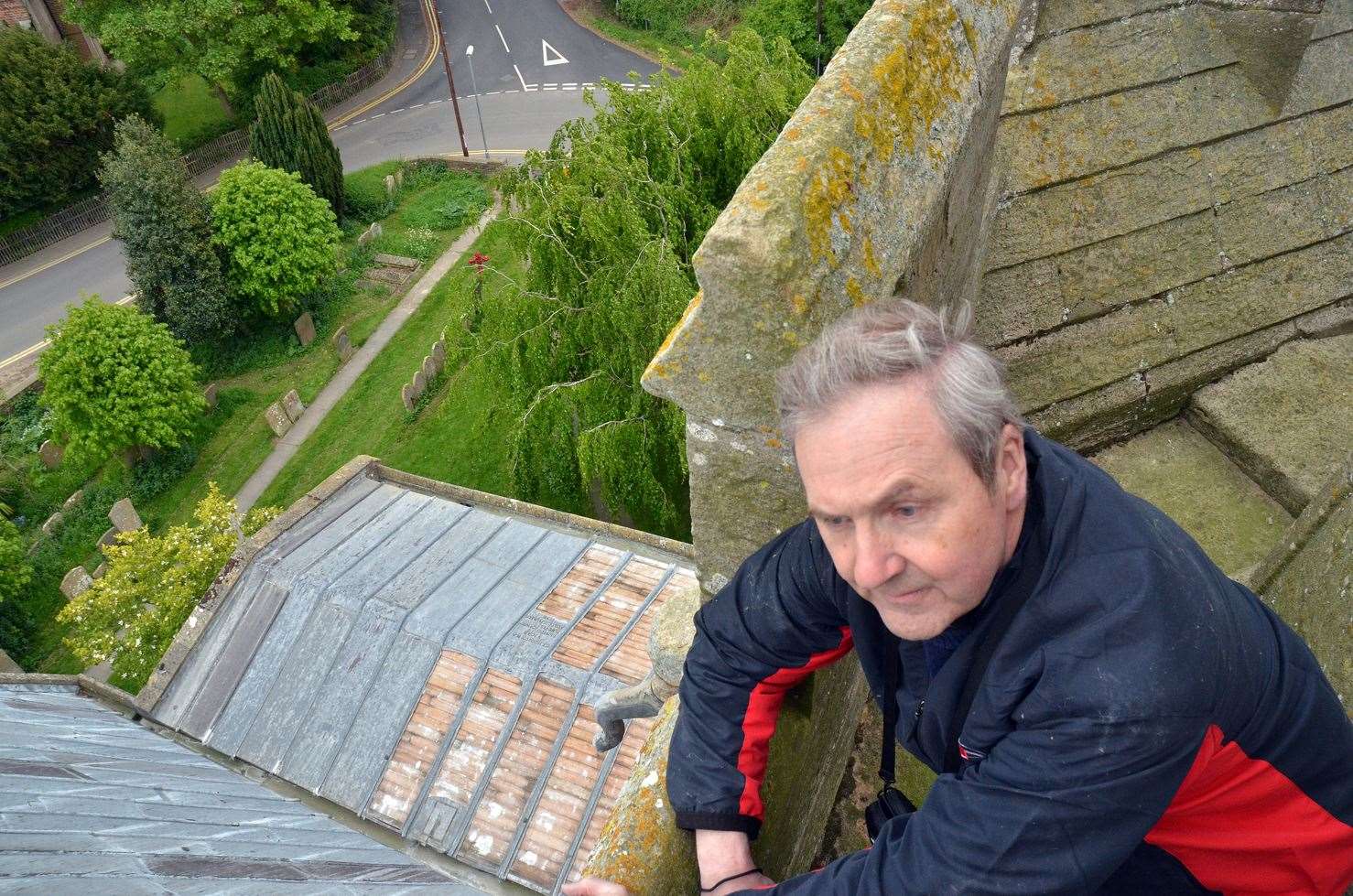The Rev Ian Walters on the roof of St Peter and St Paul's Church, Gosberton, after lead was stripped off it twice within 48 hours. Photo by Tim Wilson. SG160519-052TW.