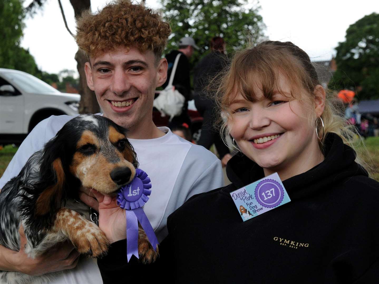 Dylan Ashman (left) and Abby Murphy (right) with Ace the dog who won Best Happy Dog in the dog show. Photo: Chris Lowndes