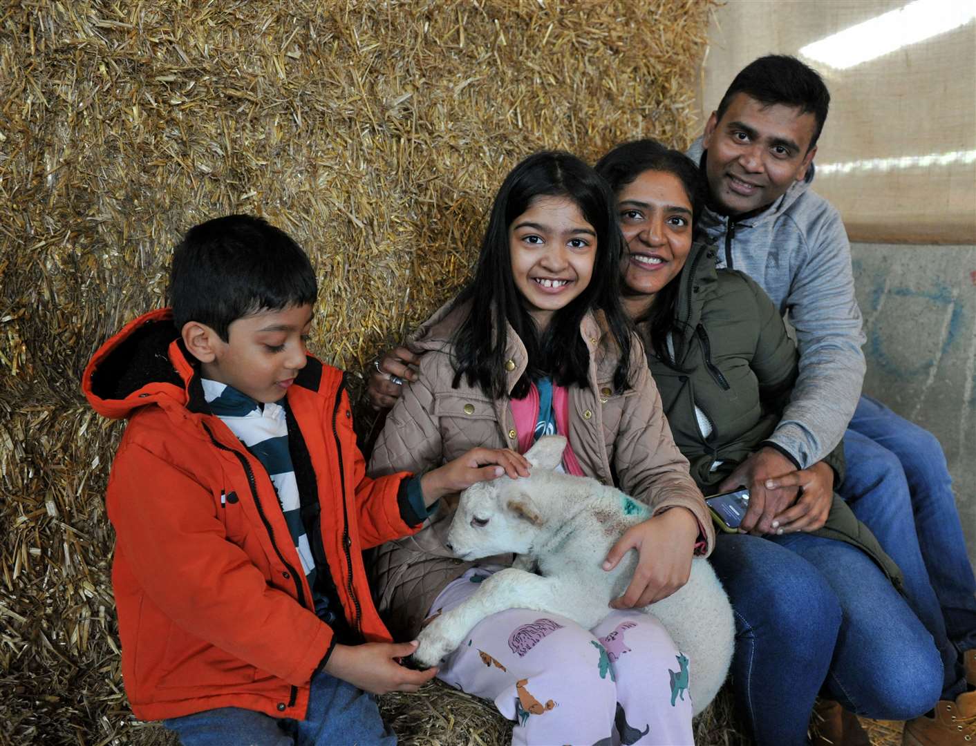 Krishna and Shravani Nagubadi with Krushaal, 5, and Kruthi, 8, who are besotted by their fleecy young friend