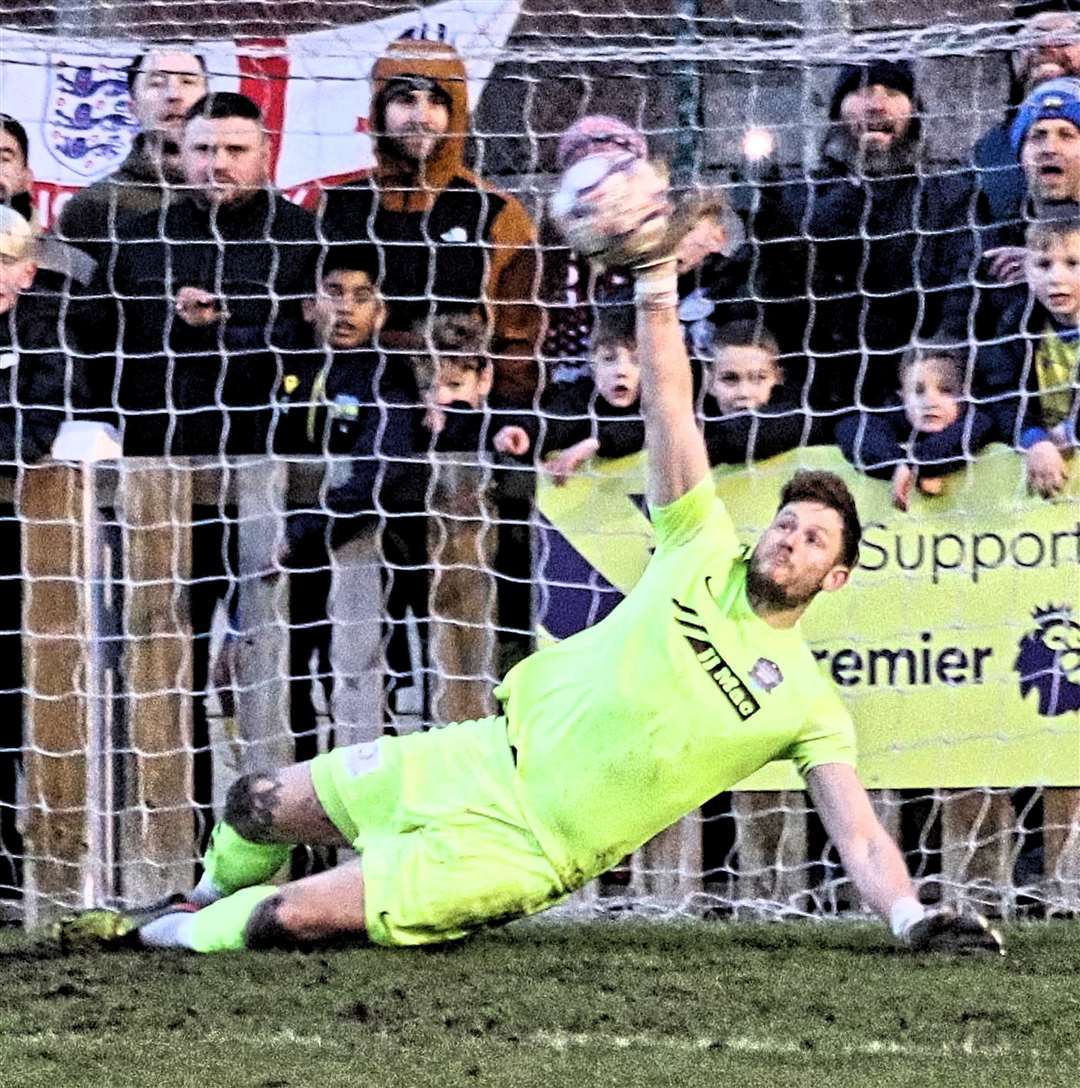 Dan Swan saves the second penalty in the last 16 victory. Photo: Dave Mears