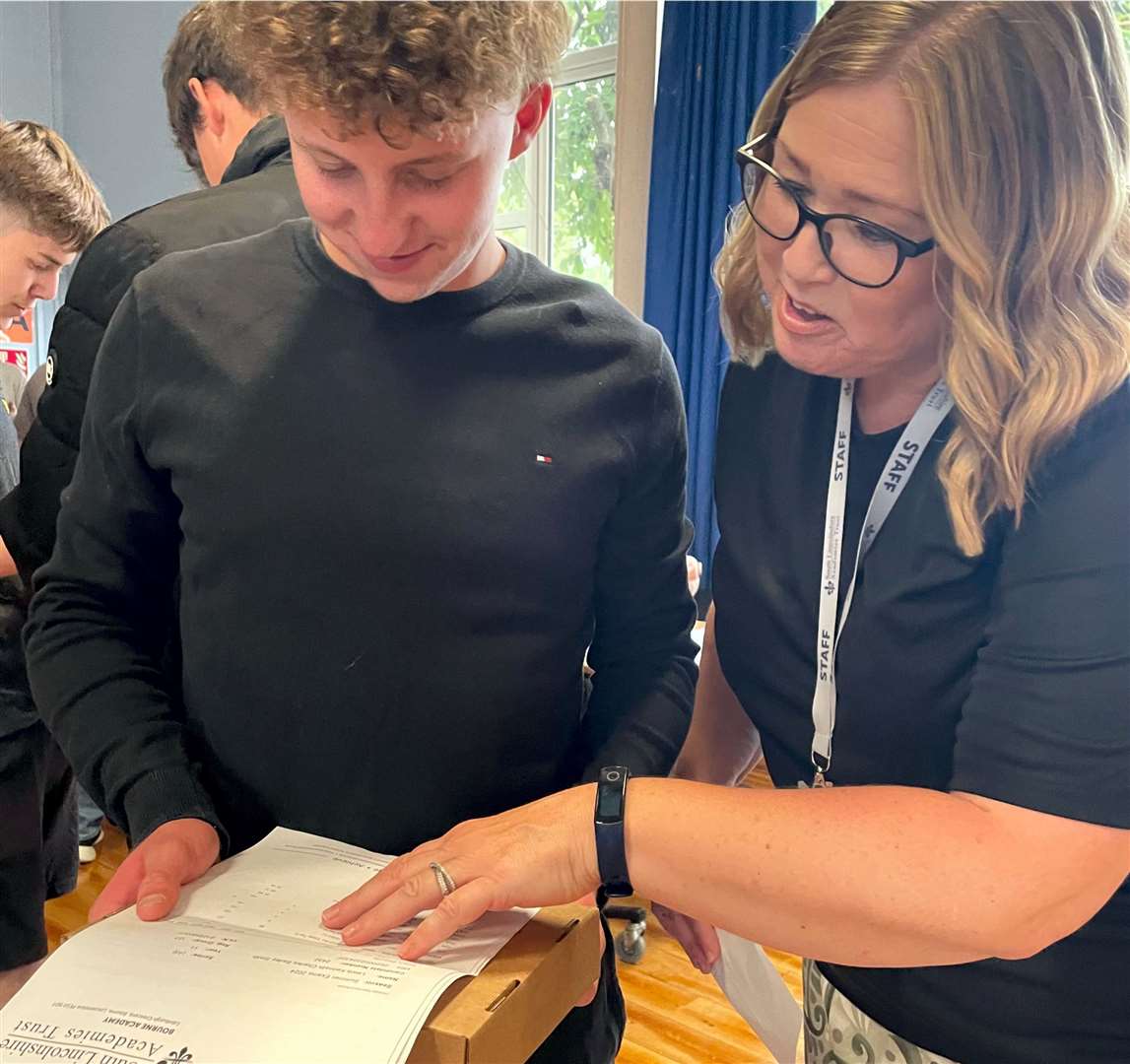 Pupils at Bourne Academy celebrate their GCSE results. Pictured is Lewis Smith with Miss Lynas, Year 11 pastoral lead