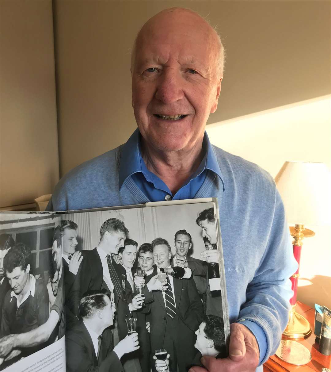 Jeff poses with a photograph of his younger self celebrating with team-mates after the Busby Babes won their first league title in 1955/56. Photo: Chris Harby