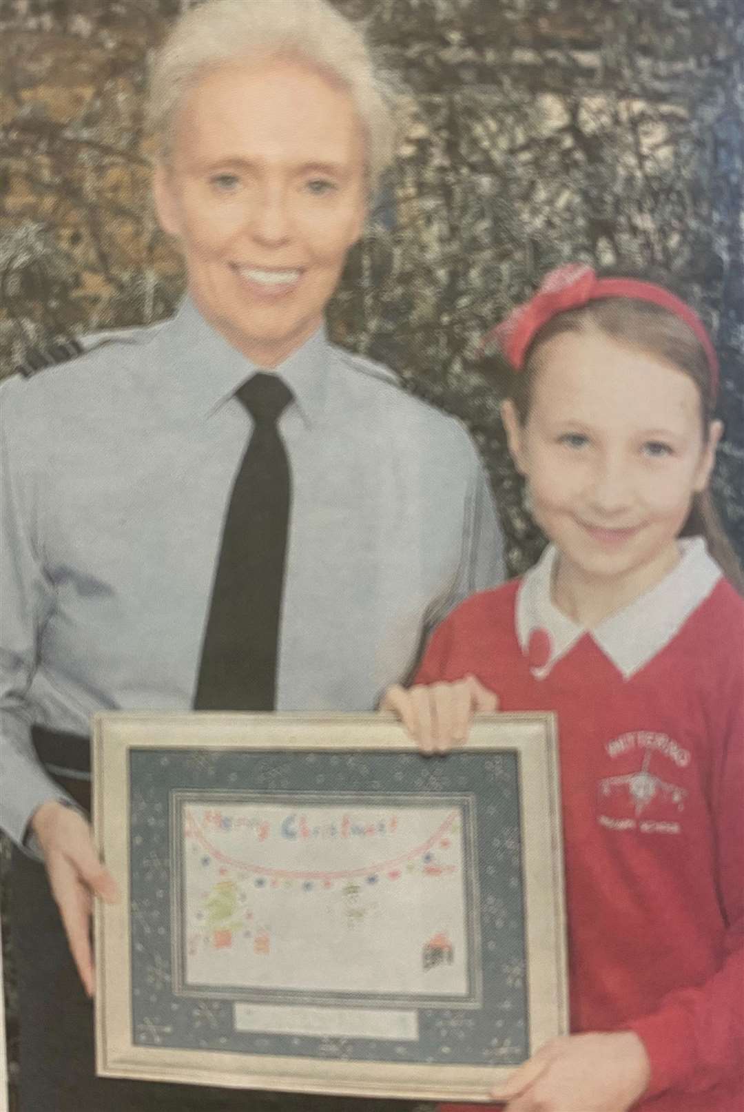 Ellie-May receives a framed card from Wing Commandeed Lizzy Nicholl 10 years ago.