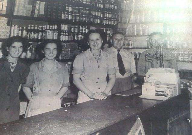 The grocery shop of George Johnson in Sutton St James. Left to right: Linda Spinks, Janet Heanes (Stanley Chapman's cousin), Freda Johnson (George's sister), George Johnson, Stanley Chapman.