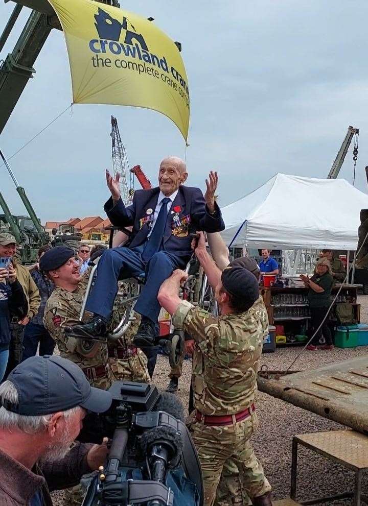 Ernie Covill lifted into the air by soldiers from Catterick army base.