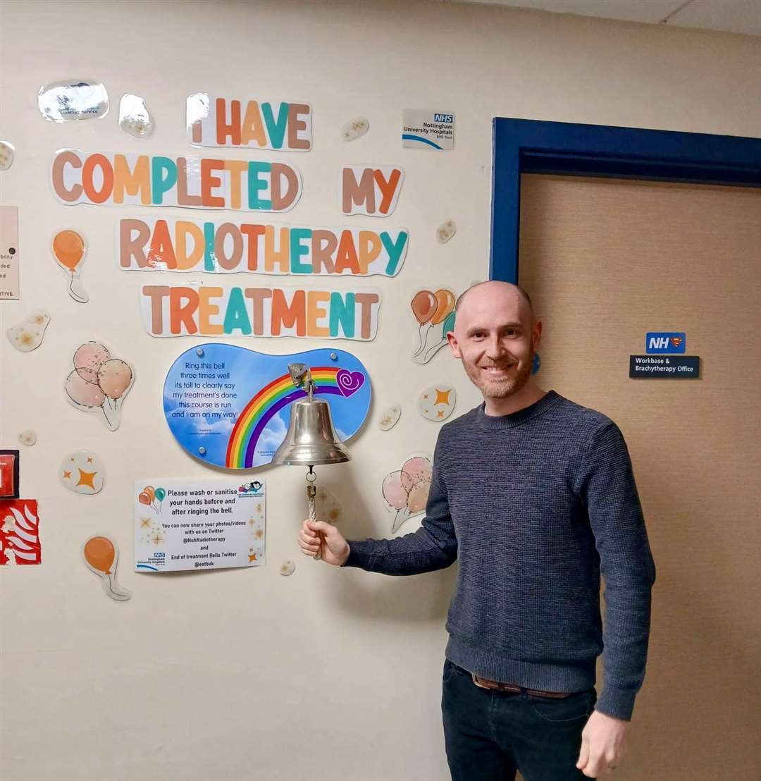 Andrew Hirst rings the bell to signify the end of his cancer treatment.