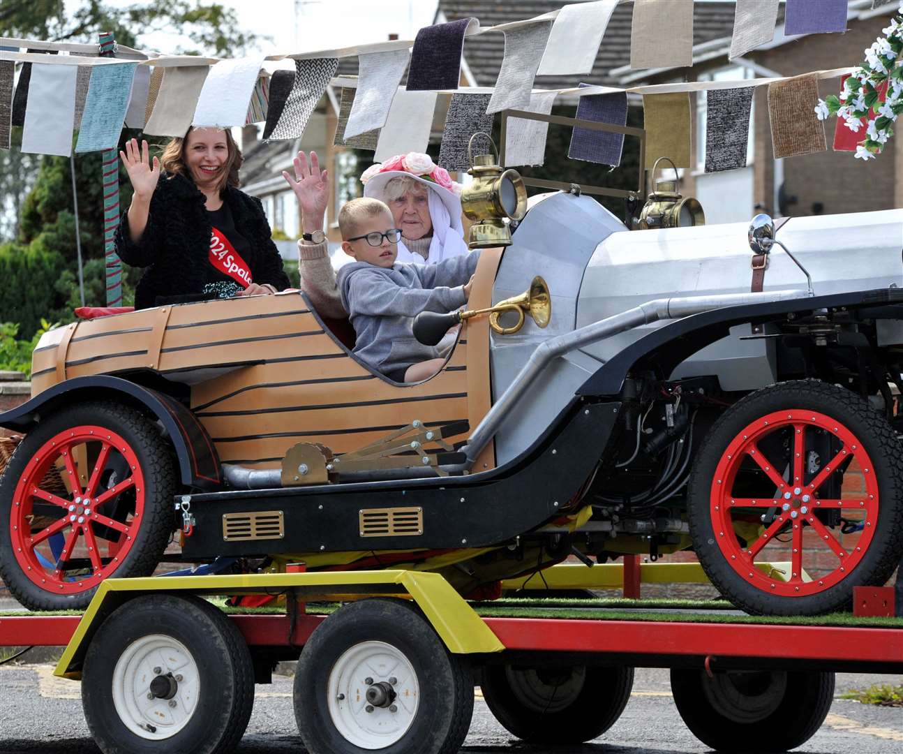Flower queen Becs Roberts enjoying a ride in the parade