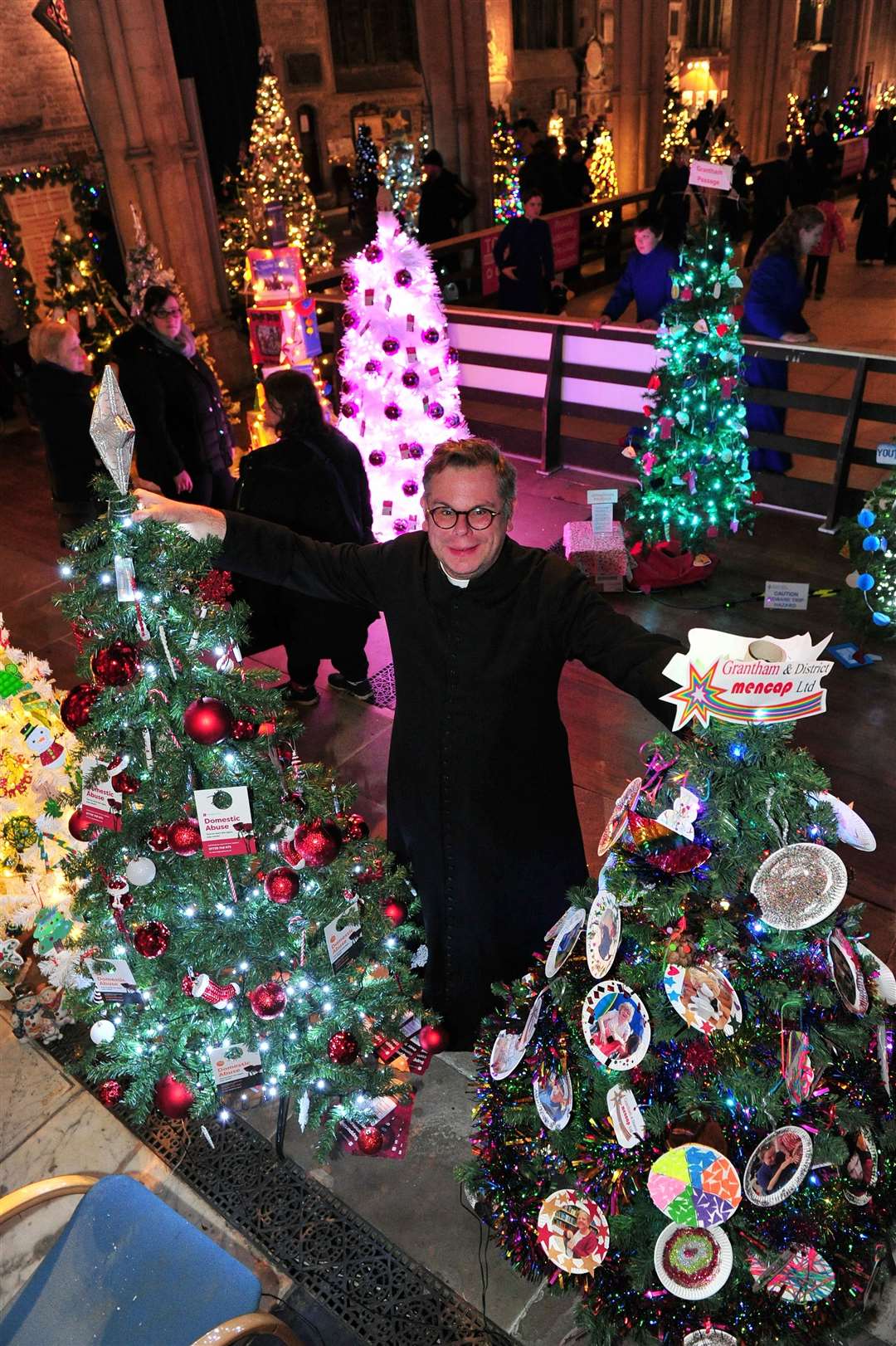Father Stuart Cradduck with some of the trees.