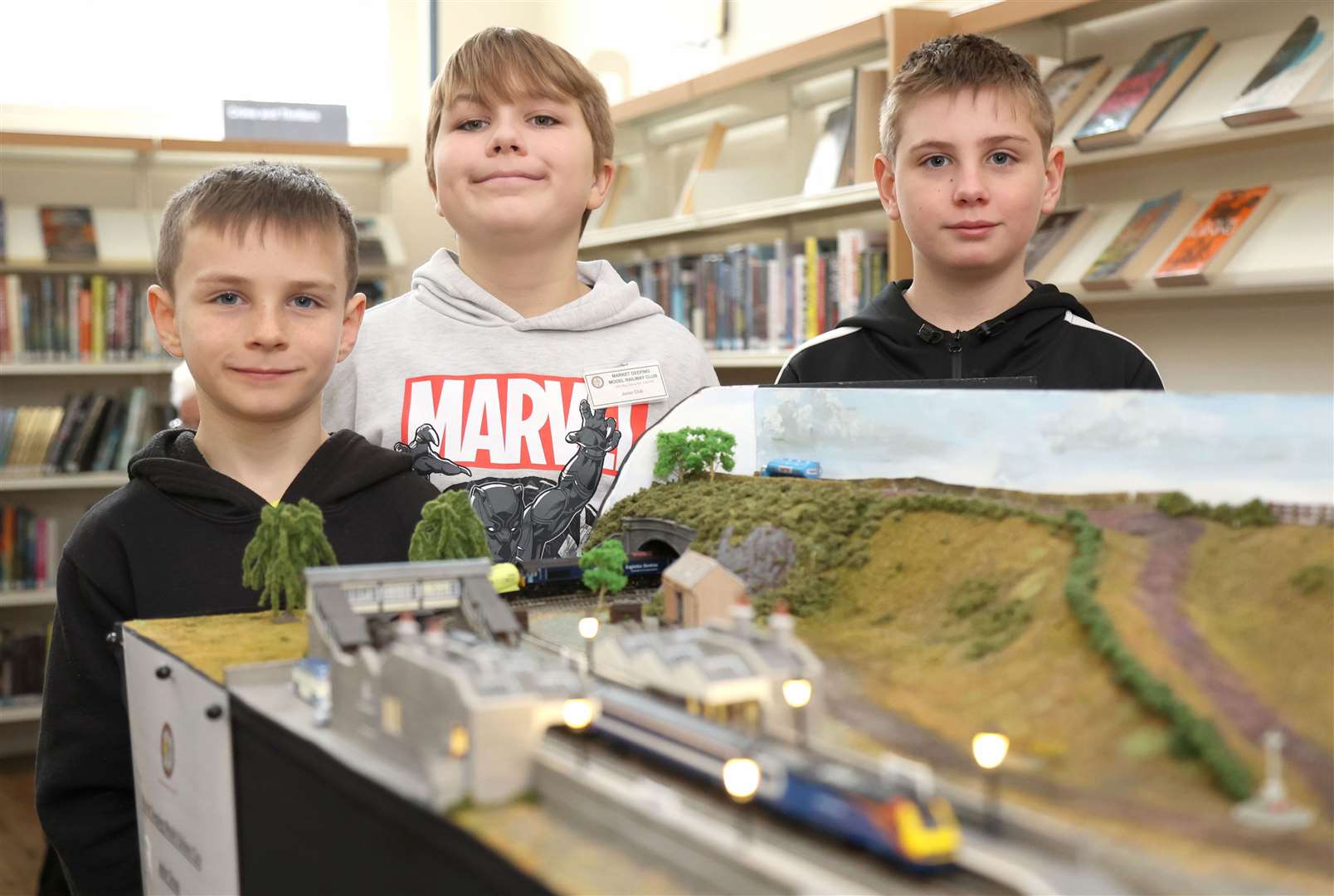 Eight-year-old Harley, Kohle, 11, and Harrison, 10, with one of the junior group's layouts