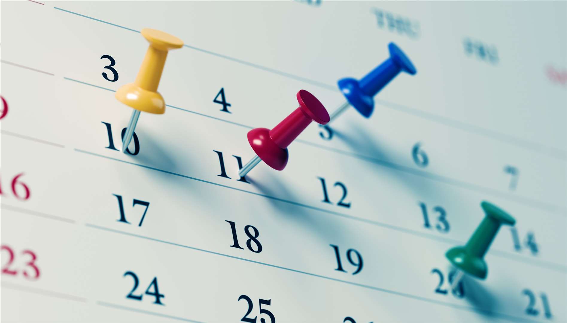 Calendar with coloured push pins. Photo: istock