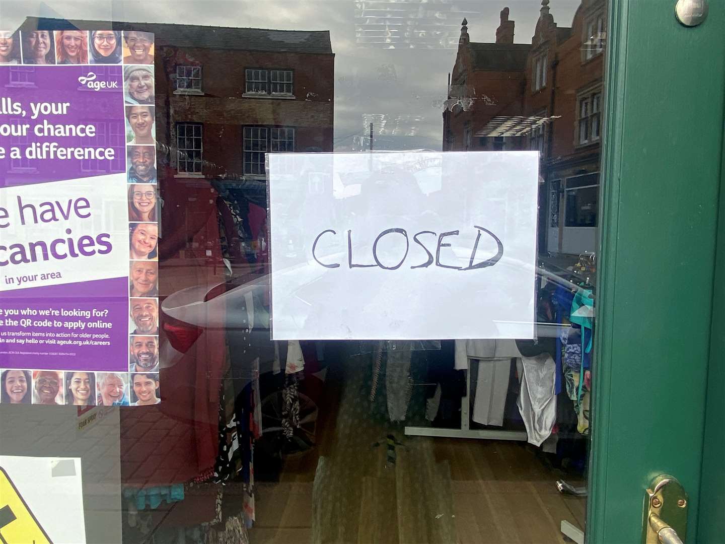 The closed signed displayed on the front door.