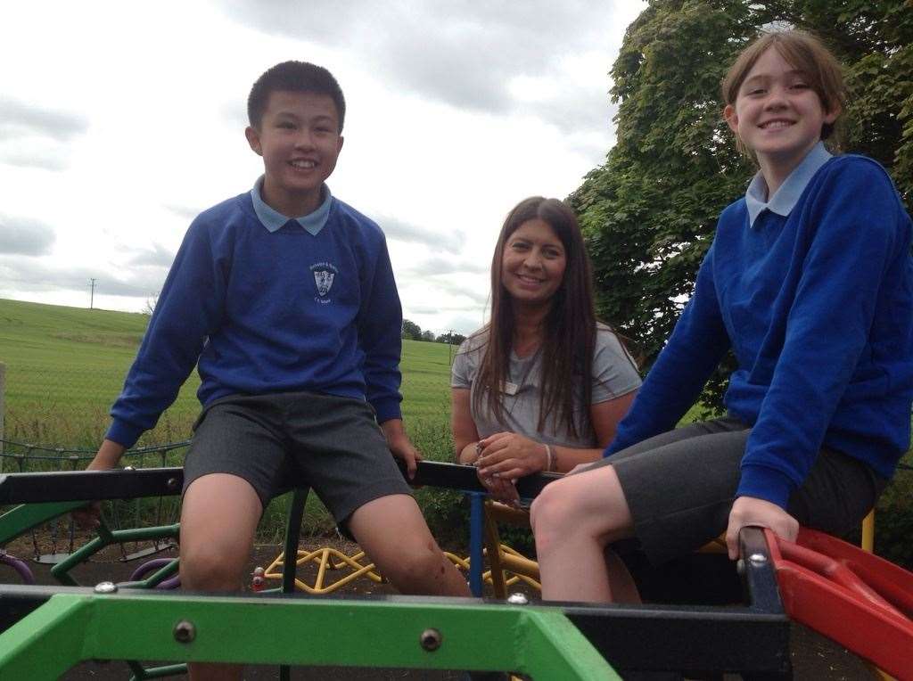 Headteacher Rebecca Lyon (middle) with children in the playground at Barkston and Syston Primary School.