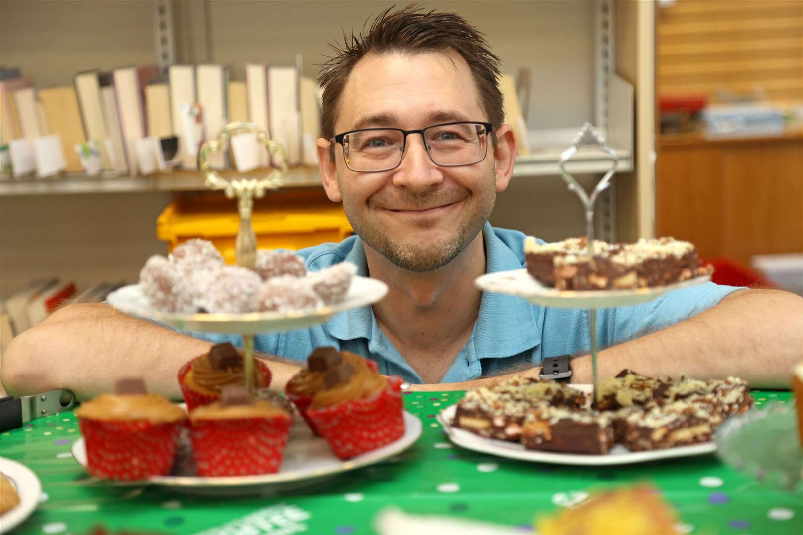 Neil Evans (senior library assistant) with some delicious cakes at a previous coffee morning