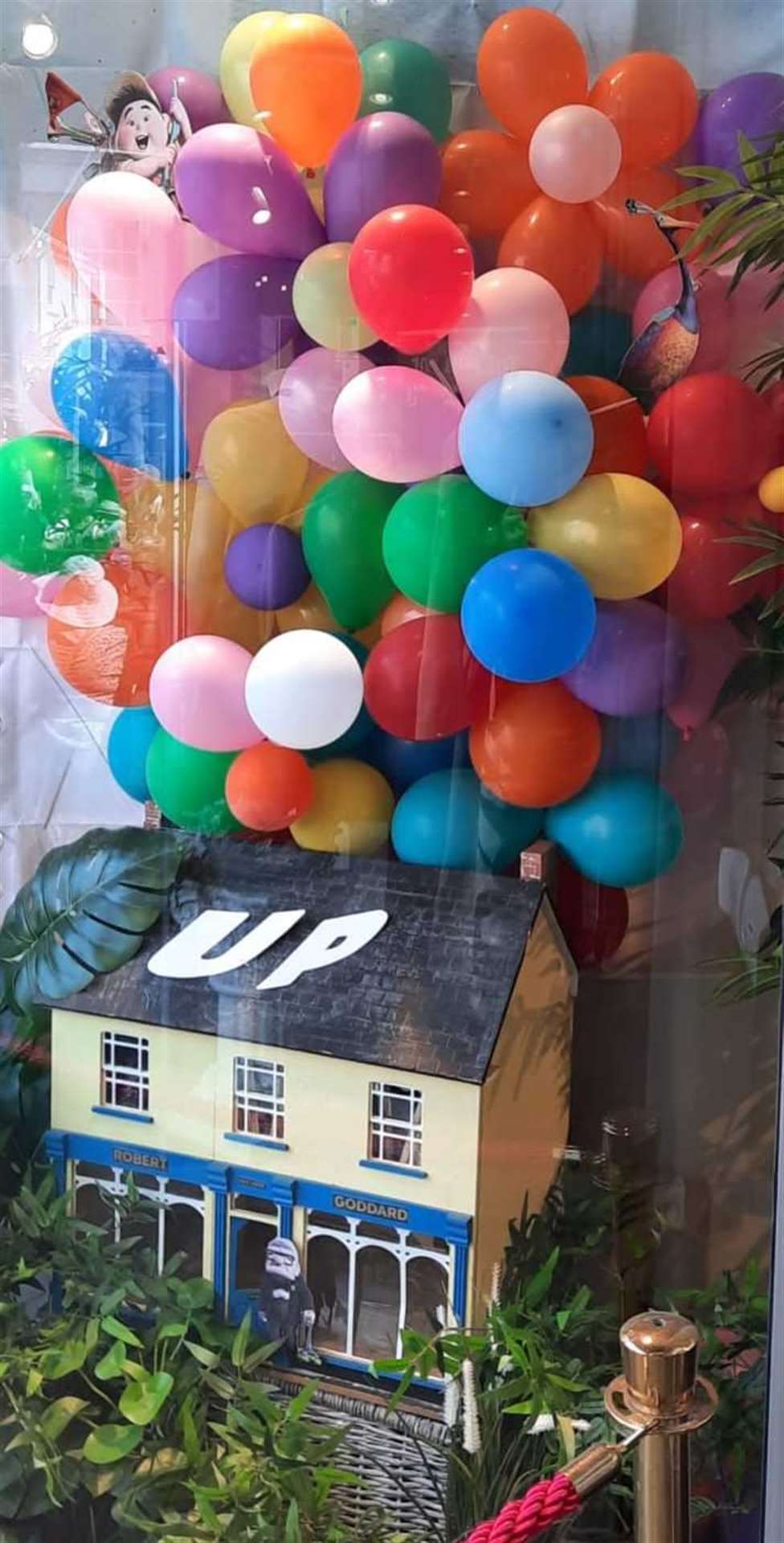 The window display at Robert Goddard based on the comedy animation film Up as part of the Spalding Flower Parade competition