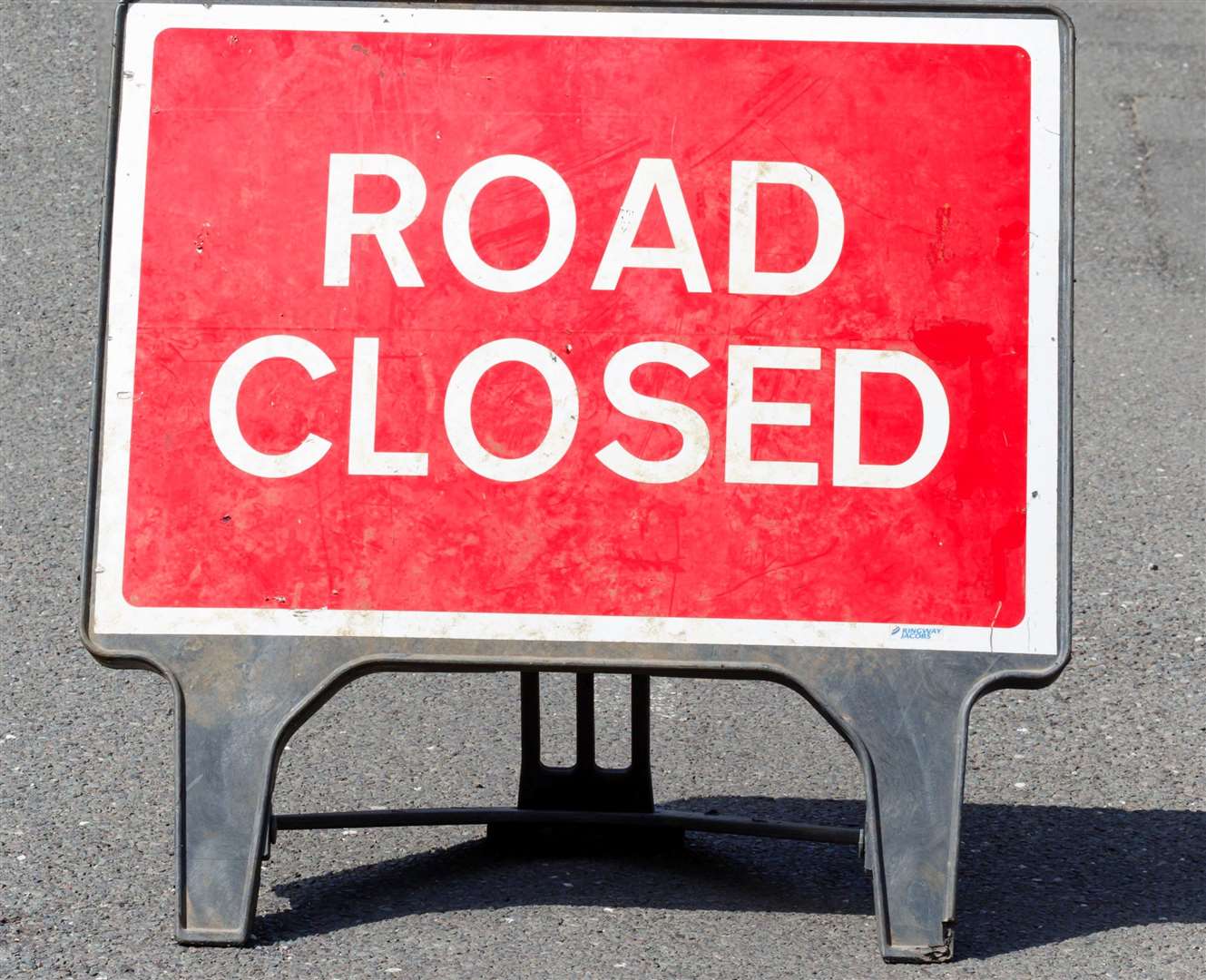 Road sign on a street showing a road closure.
