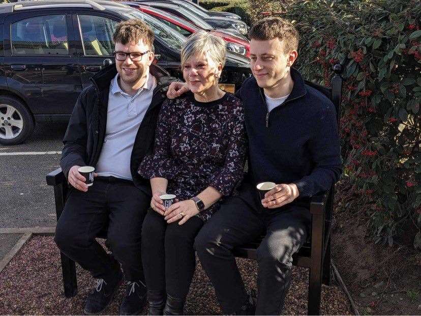 Sons Thomas (left) and Niall with wife Lesley on the memorial bench.