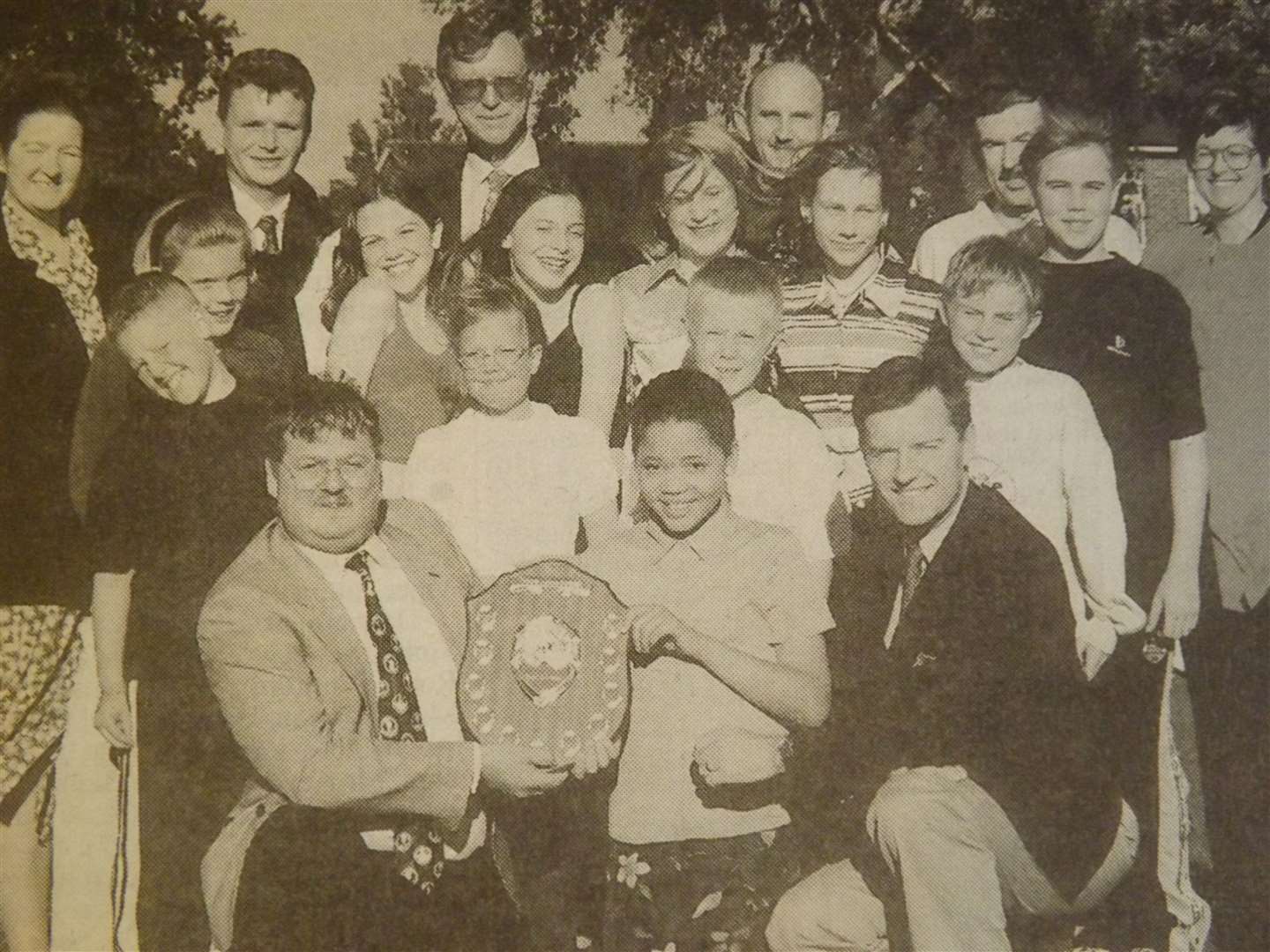 25 years ago: July 31, 1998 – Andy Garth (left) presents the Wittering Youth Club shield to junior member Chloe Parker (10) and Gp Capt Chris Moran, joined by youth club members and guests.