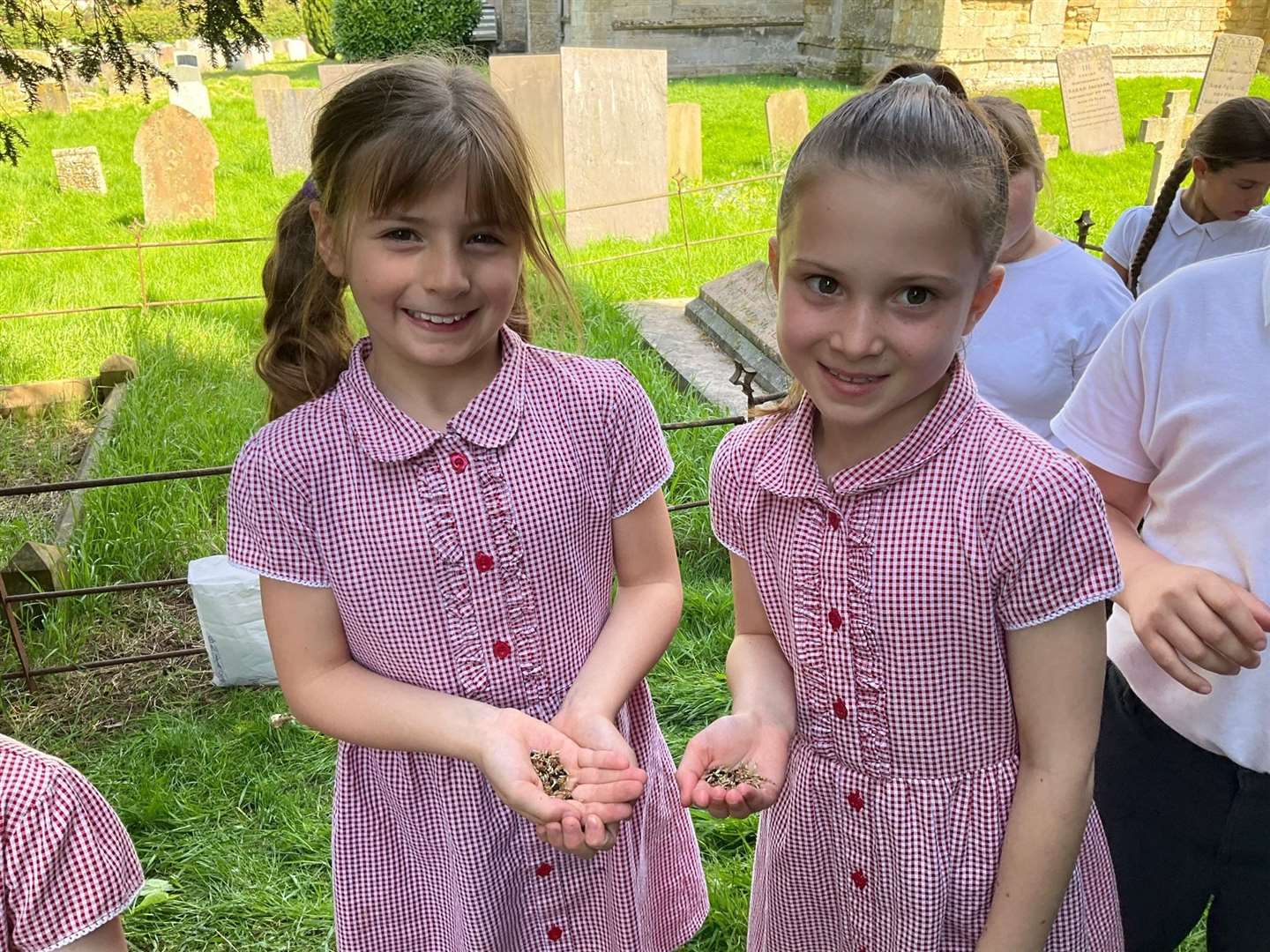 Smiley pupils planting the seeds.